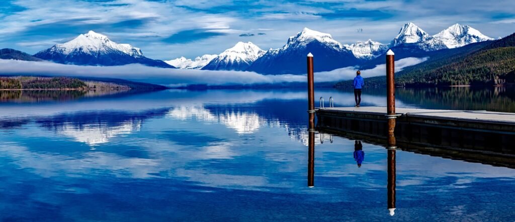 pexels photo 206353 206353 A serene lake with snowcapped mountains reflecting in the water, enhancing the tranquil outdoor setting.